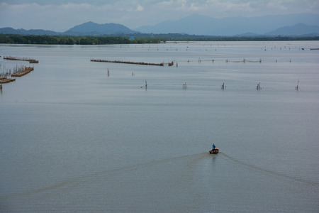 small boat Cruising in the riverの写真素材