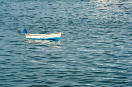 Single boat floating on a andaman sea surface