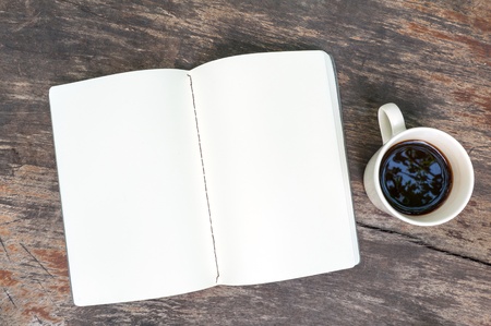 Open blank note book with coffee cup on grunge woodの写真素材