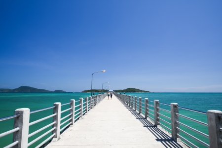 Concrete walk bridge across the sea with the blue sky at rawai beach, phuket Thailand の写真素材