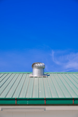Turbine roof ventilation system on top of metal sheet roof の写真素材
