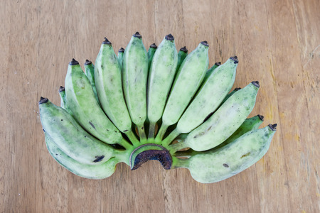 Raw green Banana on wooden tableの写真素材