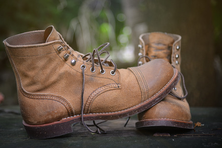 Men Brown suede boots on grungy wood