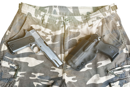semi automatic handgun on camouflage pant