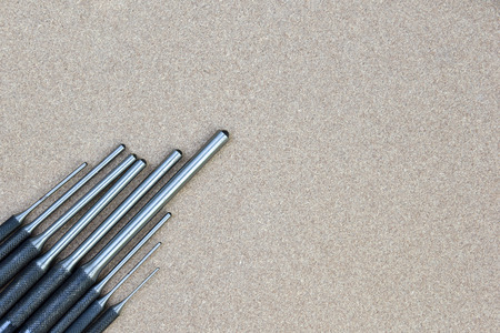 roll pin punch set tools for remove pin or latch of any mechanical object lying on wood background...
