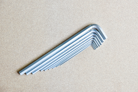 metal hex keys lying to arrange sizing from small to big on a wooden backgroundの写真素材