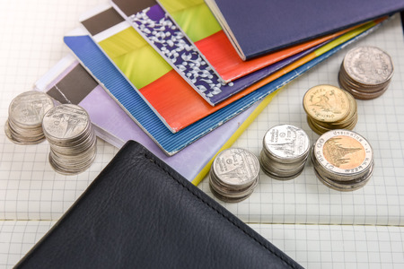 Thai money and bank saving account book on wooden table, money savings concept