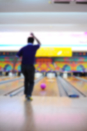blurred of a man playing bowlingの写真素材