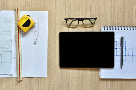 a top view of architect working desk with equipments for drawings pens sketched idea on wood table,...