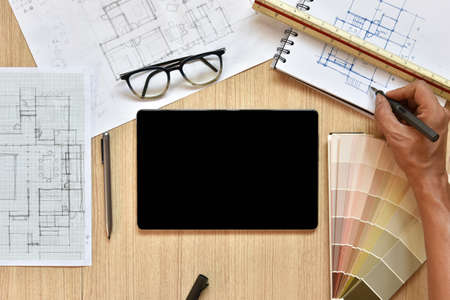 a top view of architect working desk with hand work on equipments for drawings pens sketched idea on...