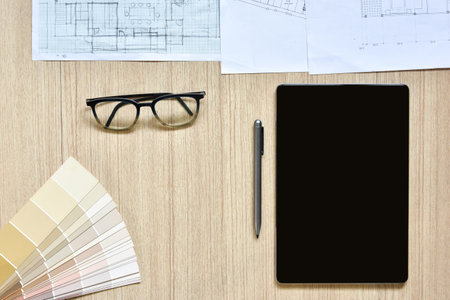 a top view of architect working desk with equipment for drawings pens sketched idea on wood table,...
