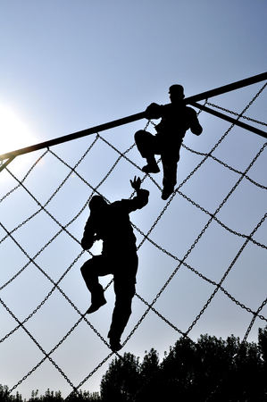 silhouette of athlete climbing