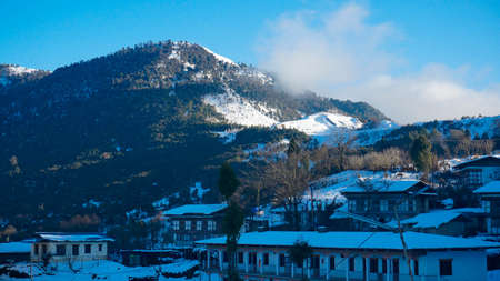 View of the snow-covered mountain village in the middle of the valley