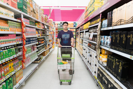 ANGTHONG, THAILAND - September 17 : Young man shopping in supermarket.のeditorial素材