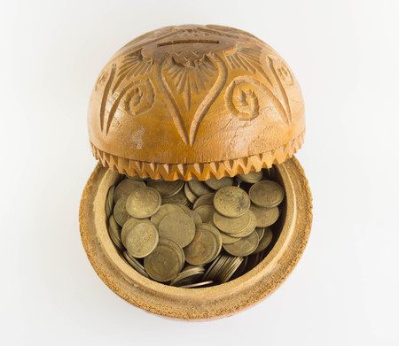 Old bowl filled with Thailand old currency on  floorの写真素材