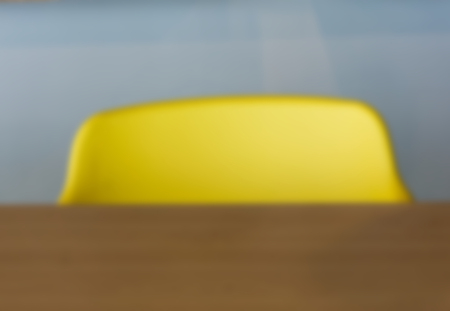 Blurred background of empty yellow  chairs at the deskの写真素材
