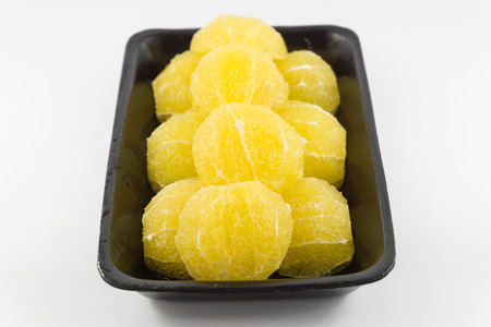 Slices of fresh orange fruit in plate on white backgroundの写真素材