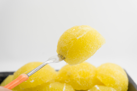 Slices of fresh orange fruit in plate on white backgroundの写真素材