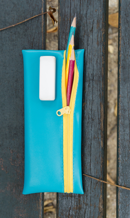 pencil over wooden background