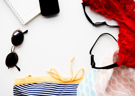 Top view travel set, sunglasses, phone, book, swimwear, Underwear, hat, copy space.