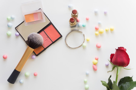 Top view make up with colorful balls and red rose on white background.の写真素材
