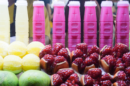Fresh fruit juices in bottles, night market in Bangkok Thailand.の写真素材
