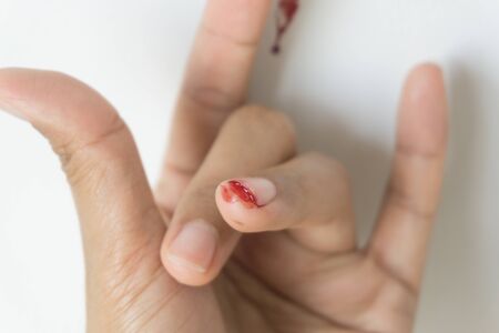 Red blood from finger, Fingers making the I Love You symbol.
