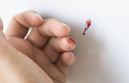 Red blood from finger on white background.の写真素材