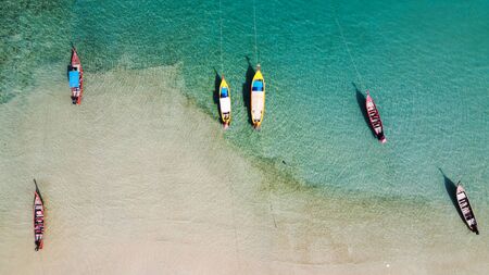 Aerial view of Thai traditional wooden longtail boat on Phuket beach, Thailand, Top view from flying drone.の写真素材