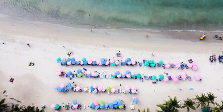 Aerial view of Tourists on the sand beach, colorful umbrellas.の写真素材