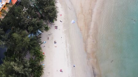 Aerial view of tourists in beautiful sandy beach in Thailand.