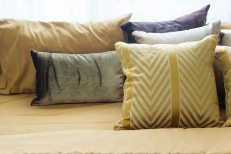 Various colorful pillows on the bed, nobody.の写真素材