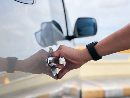 Man opening a car door.の写真素材