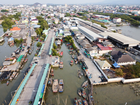 Views of the dense village, and fishing occupation, local fishing boats moored at the bridge, Chon Buri, Thailand.の写真素材