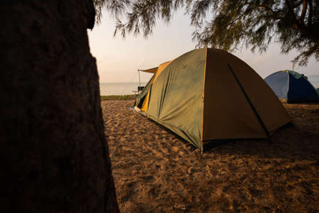 A tourist's tent is at the beach in the morning, time to enjoy nature.の写真素材