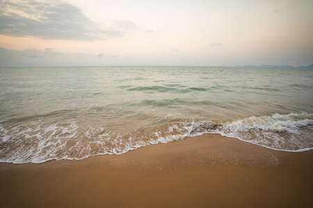 The beach and the sky are beautiful in the morning, dark tones.の写真素材