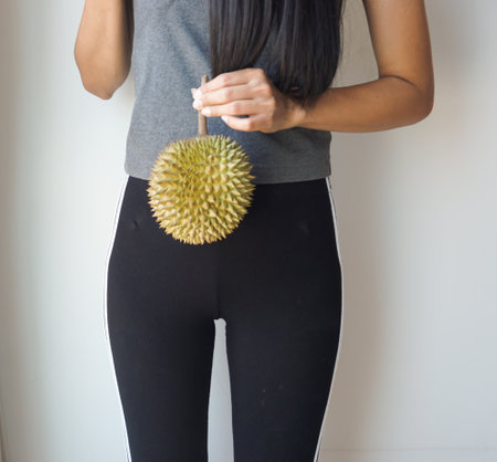 Asian slim woman holding durian, king of fruit in Thailand, delicious.の写真素材