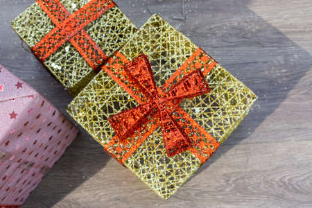 Golden gift box with red bow, festivals and celebrations concept.の写真素材