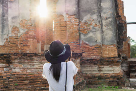 Asian female tourists taking pictures at Wat Phra Si Sanphet, Phra Nakhon Si Ayutthaya, Thailand.の写真素材