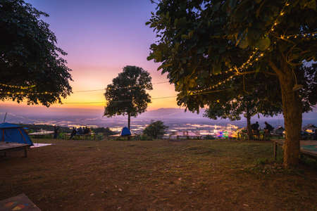 A group of camping tourists are enjoying the evening against the beautiful evening sky.の写真素材