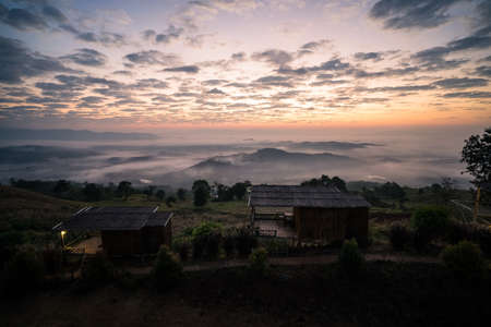 Old wooden houses with misty nature in the morning.の写真素材