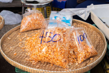 Orange dried shrimp in bags for sale in the market, Thailand.の写真素材