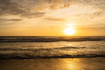 Colorful ocean beach sunset, Orange and golden sunset sky.の写真素材