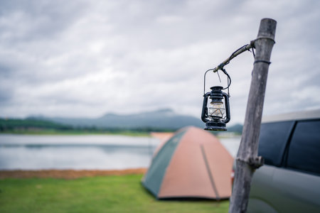 Camping lantern with tent background and beautiful mountains.の写真素材
