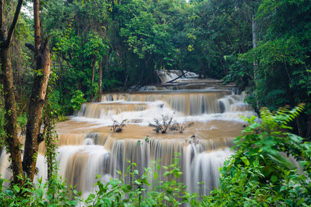 Jungle waterfall in tropical rainforest in Thailand, Brown waterfall after heavy rain.の写真素材