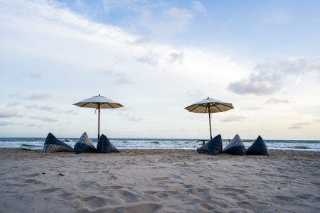 Beach with seats and parasols by the sea, sand and blue sky.の写真素材