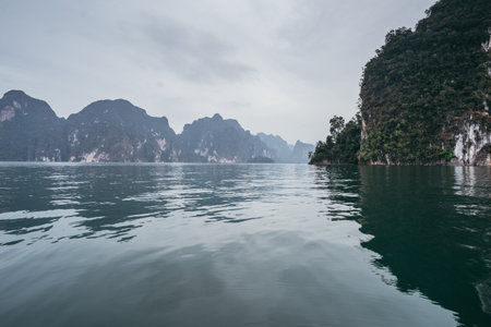 Blue sea water and large rocky mountains in the middle of the sea.の写真素材