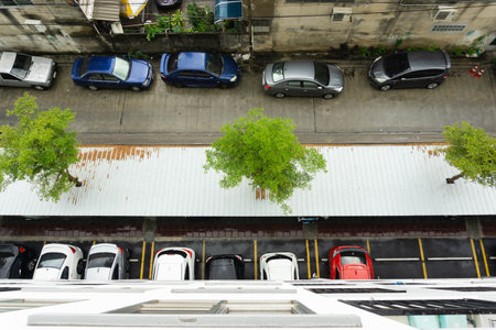 Top view of Cars are parked in the condo parking lot, and some cars are parked on the road.の写真素材