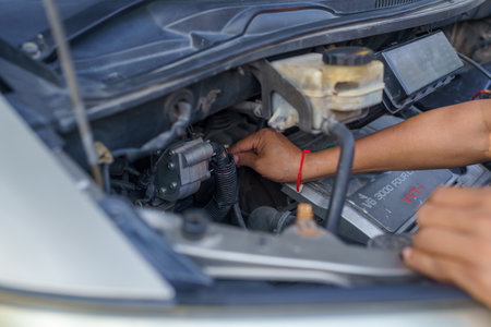Man's hands repairing car, Car radiator repair, Repair service.の写真素材