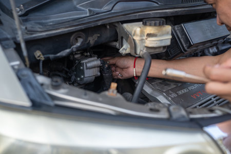 Man's hands repairing car, Car radiator repair, Repair service.の写真素材